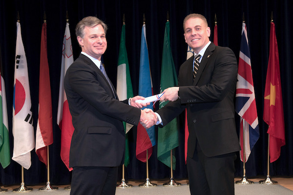 Major Eric Flower, on right in photo, graduates from the FBI Academy.