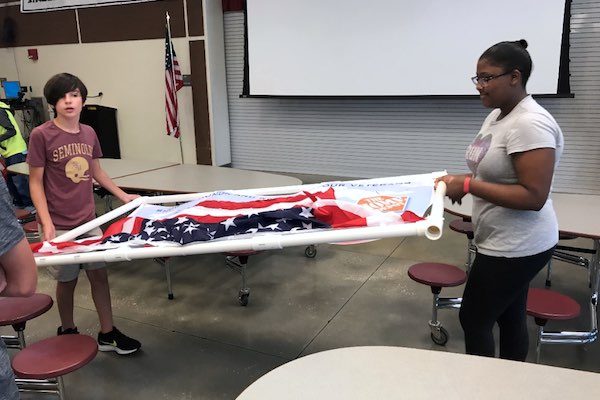 Student volunteers at Storm Grove Middle School building the first round of signs.