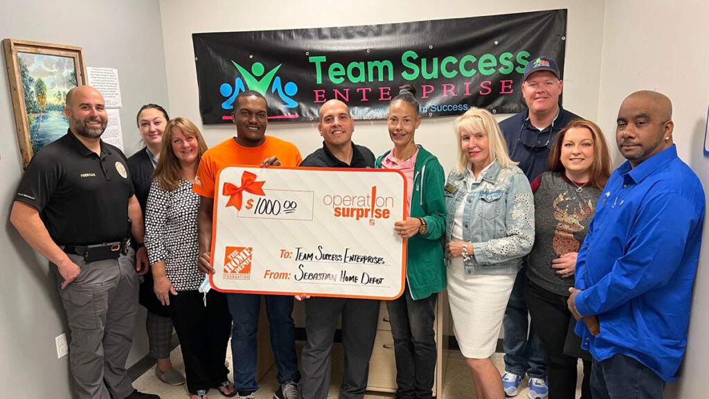 Home Depot presents check to Team Success Enterprises.