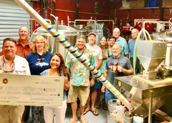 Pareidolia Brewing Company presents check to Hibiscus Children's Center