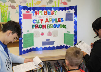 High school Navy JROTC Cadets judge elementary science fair in Sebastian, Florida.