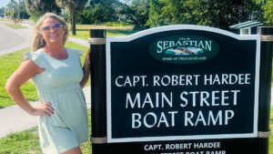 Scarlett Chesser in front of the Capt. Robert Hardee Main Street Ramp sign, marking a notable spot in the city
