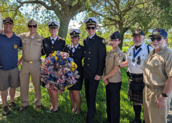 Ross Rowlinson (left) poses for a photo with Michael Hyde (second from right) and Sebastian River High School Navy JROTC personnel (from left to right) CDR (ret) Bissonnette, Cadet Bowen, Cadet Ortiz, Cadet Denning, Cadet Lopez.