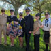 Ross Rowlinson (left) poses for a photo with Michael Hyde (second from right) and Sebastian River High School Navy JROTC personnel (from left to right) CDR (ret) Bissonnette, Cadet Bowen, Cadet Ortiz, Cadet Denning, Cadet Lopez.